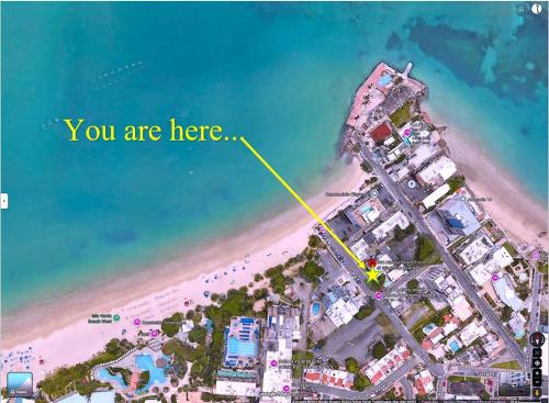 an overhead view of a beach with the words you are here at Beachfront Oceanview Wifi Self Check in in San Juan