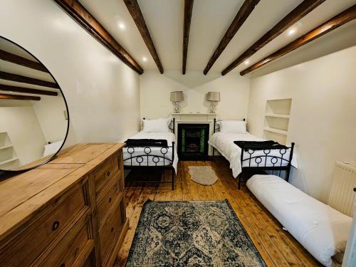 a bedroom with two beds and a mirror at 3 Bed in Kirriemuir 96317 in Logie