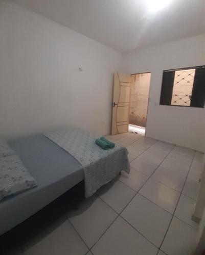a small bedroom with a bed and a tiled floor at Centro - Praia de Iracema - Pousada Panorama do Mar in Fortaleza