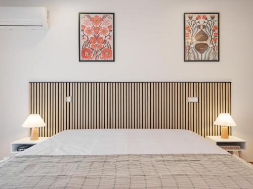 a bedroom with a large white bed and two lamps at Dom Carlos Villa in Vila Nova de Gaia