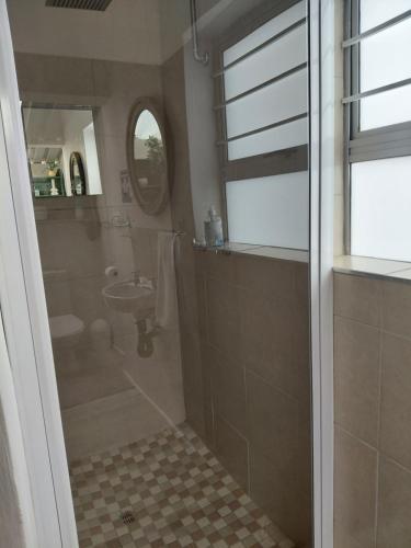 a bathroom with a shower and a sink at Cenikma Guest Suites - Family Room 1 in East London