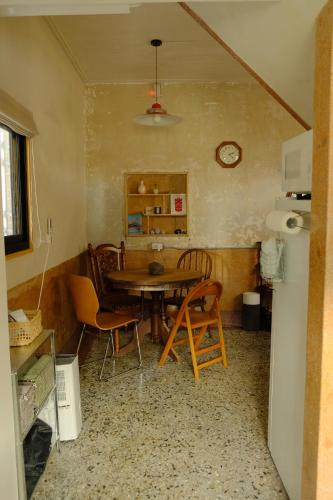 a kitchen with a table and chairs in a room at Tomo 伴 in Tainan