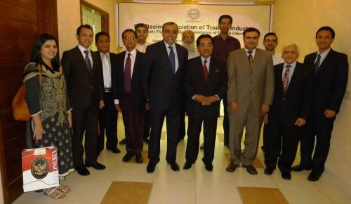 a group of men in suits posing for a picture at The Enterprise in Karachi