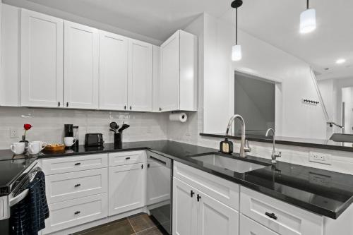 a white kitchen with white cabinets and a sink at New Luxury Pearl Townhome-Casa A in San Antonio