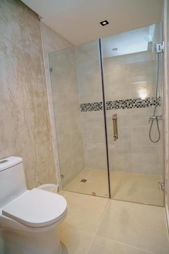 a bathroom with a shower with a toilet at HOTEL K2 in Higuey