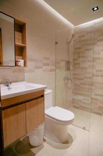 a bathroom with a toilet and a sink and a shower at HOTEL K2 in Higuey