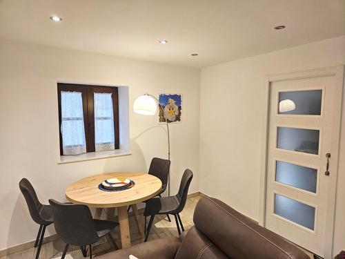 a living room with a table and chairs and a lamp at Mural del Castillo II, La Alberca in La Alberca