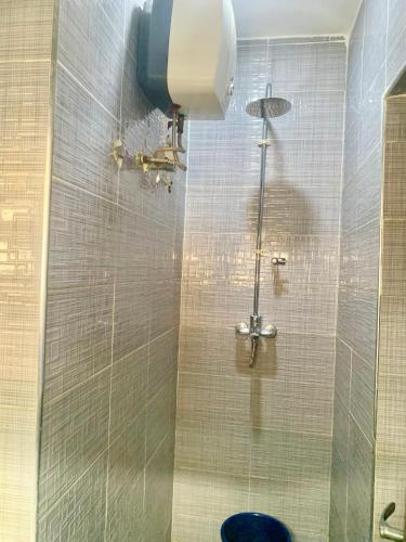 a bathroom with a shower with a toilet at Cbox Lodge & Lounge in Lagos