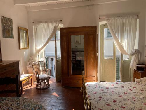 a bedroom with a bed and an open door to a balcony at A&A Massara in Bergamo