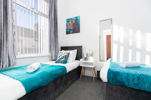 a bedroom with two beds and a window at Newly Renovated 3br House Near Hospital & Uni in Sunderland
