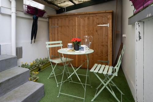 a small table and chairs on a patio at Maison Loft Verzy - Nomad by Welkeys in Paris