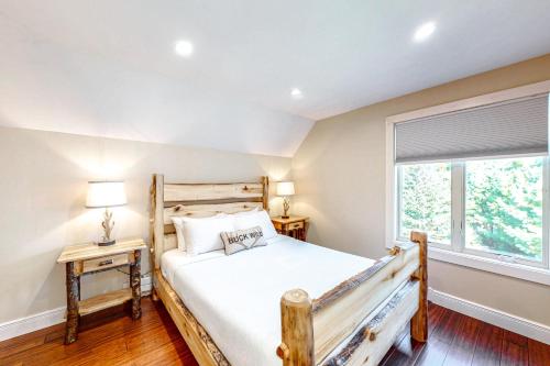 a bedroom with a wooden bed and a window at Nesting in North Creek in North Creek