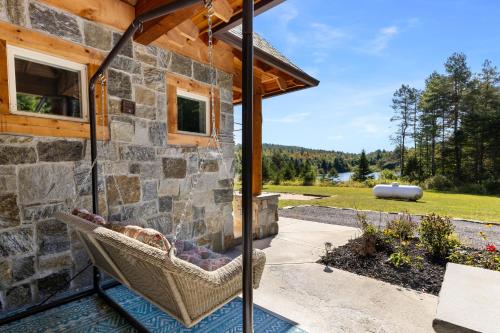 a stone house with a hammock on a patio at Nesting in North Creek in North Creek