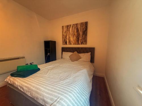 a bedroom with a large bed with a painting on the wall at Newcastle City Centre, Two Bedroom, Sleeps 6 in Newcastle upon Tyne