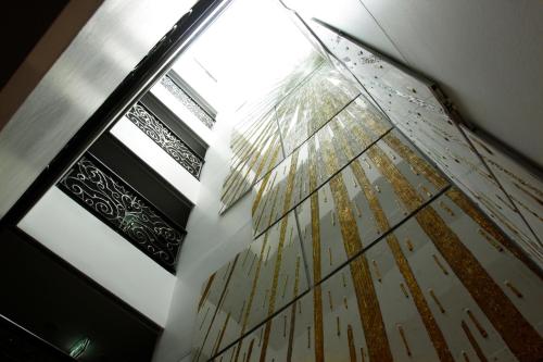 a reflection of a umbrella on the floor of a building at Aspira Skyy Sukhumvit 1 in Bangkok