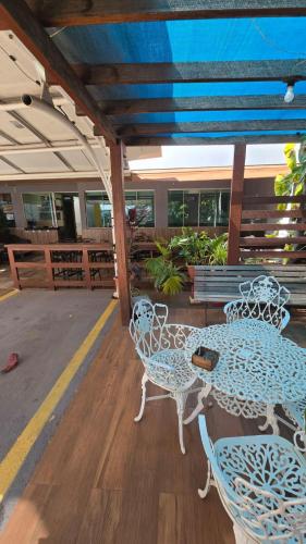 a patio with a table and chairs on a deck at Hotel Pousada Aeroporto in Goiânia