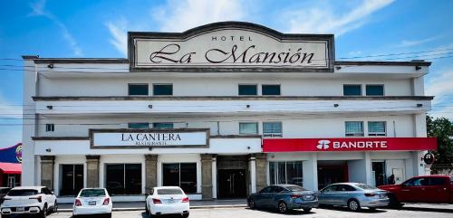 a building with a sign for a hotel la mansion at Hotel La Mansión 