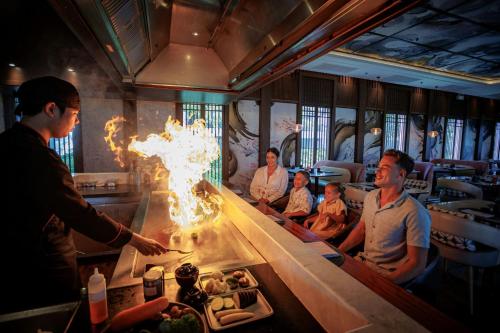 a group of people sitting at a table in a restaurant at Marriott Vacation Club, Khao Lak Beach Resort in Khao Lak
