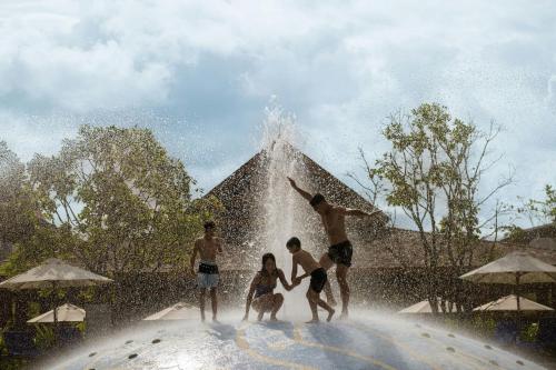 a group of people playing in a fountain at Marriott Vacation Club, Khao Lak Beach Resort in Khao Lak