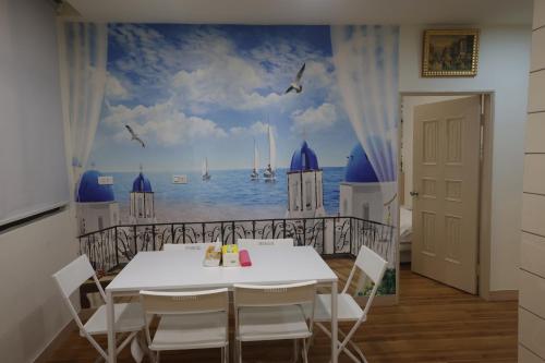 a dining room with a table and a view of the ocean at Sea Keelung in Keelung