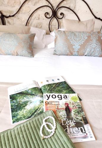 two pictures of a bed with a magazine and a book at Hôtel Mas Vidau Porte des Alpilles in Saint-Étienne-du-Grès