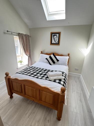 a bed in a bedroom with a skylight at Unit 4 Tranquil Harbourside Retreat- Central Location in Cobh