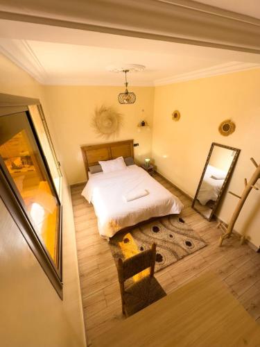 a bedroom with a bed and a mirror in it at Imsouane Vibe Surf house in Imsouane