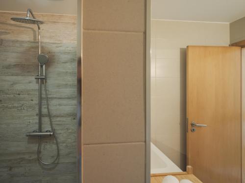 a shower in a bathroom with a glass door at Dom Carlos Villa in Vila Nova de Gaia