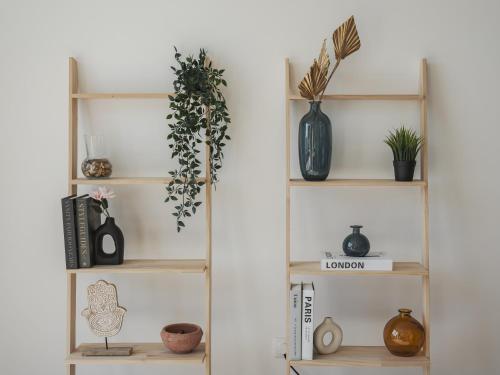 a shelf with plants and vases on it at Dom Carlos Villa in Vila Nova de Gaia