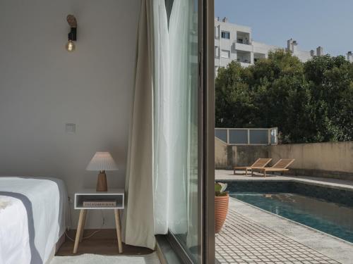 a bedroom with a bed and a view of a pool at Dom Carlos Villa in Vila Nova de Gaia