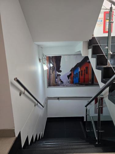 a staircase in a building with two pictures on the wall at Hotel Castellana 100 Bogota By Hoteles Confort 80 in Bogotá