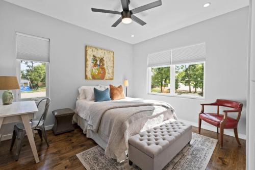 a bedroom with a bed with a ceiling fan and a desk at On Cloud Durham Unit B in Durham