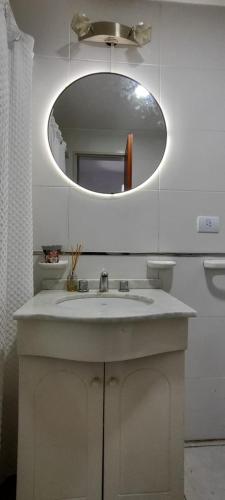 a bathroom with a sink and a mirror at Departamento Temporario Tucuman 3Personas Pileta in San Miguel de Tucumán