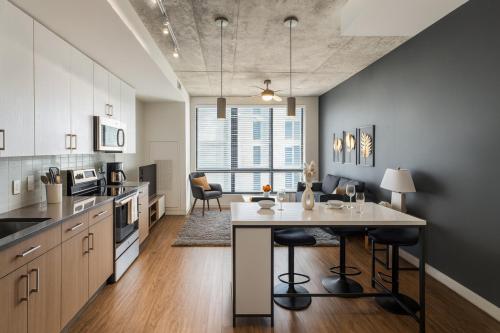 a kitchen with a island in the middle of a room at City Escape 2BR Apt with Resort Amenities in Birmingham