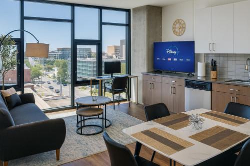 a kitchen and dining room with a table and chairs at Modern 2BR Gem Rooftop Pool and Workspaces in Birmingham