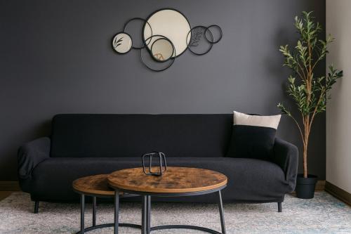 a living room with a couch and a table at Modern 2BR Gem Rooftop Pool and Workspaces in Birmingham