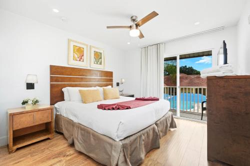 a bedroom with a large bed and a large window at Direct resort access Balcony Pool Upgraded Inside in Kissimmee