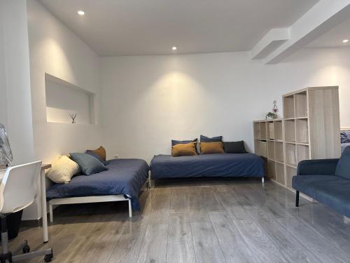 a living room with two beds and a couch at Loft Story in Lisbon Humberto Delgado Airport