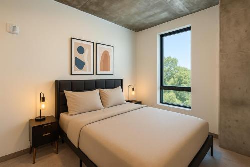 a bedroom with a large bed and a window at Bright 2BR Apt Pool, Gym Walkable Area in Birmingham