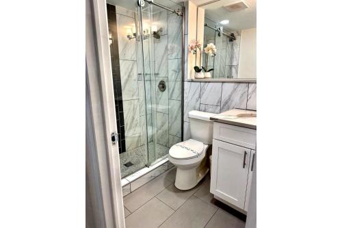 a bathroom with a shower and a toilet and a sink at World Cup 18K City View Condo Near Stadium in Atlanta