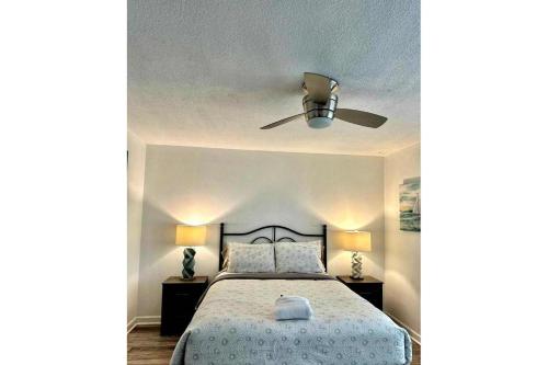 a bedroom with a bed with a ceiling fan at World Cup 18K City View Condo Near Stadium in Atlanta