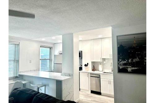 a kitchen with white cabinets and a counter top at World Cup 18K City View Condo Near Stadium in Atlanta