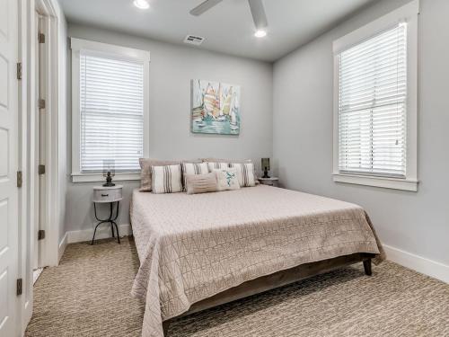 a bedroom with a bed and two windows at Shore Enough, Carlton Landing Lakeview in Carlton Landing