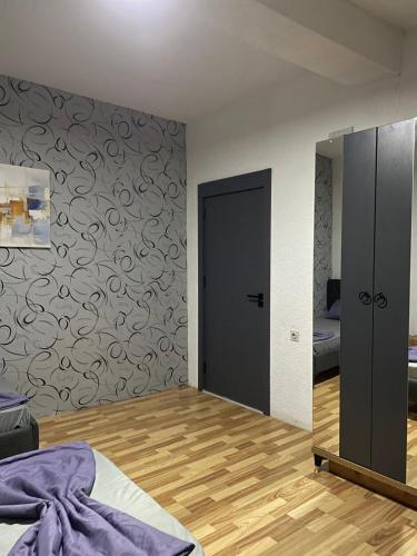 a bedroom with a bed and a mirror on the wall at Dragovca Apartment in Prizren