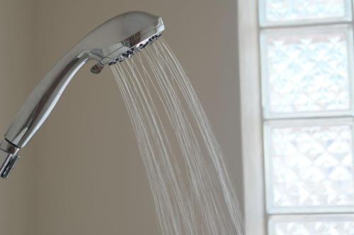 a shower with a shower head in front of a window at Sayulita beach-side studio 2 by CasasTropical in Sayulita