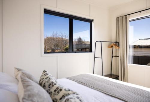 a bedroom with a bed and a window at The Alpine 2-Bedroom Villa - Roam Lake Tekapo in Lake Tekapo
