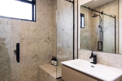a bathroom with a sink and a shower at The Alpine 2-Bedroom Villa - Roam Lake Tekapo in Lake Tekapo