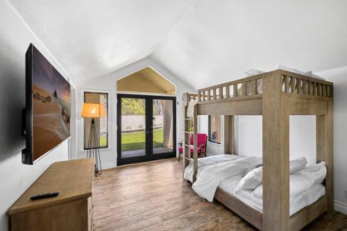 a bedroom with a bunk bed with a desk and a television at Private Gated 6BR Luxury Estate, Gym, Lake View in Del Dios