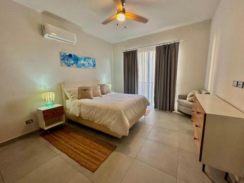 a bedroom with a bed and a ceiling fan at Casa Tortuga Cabo Paradise in Cabo San Lucas