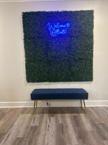 a blue bench in front of a painting on a wall at 8th Floor Stylish Downtown Condo Private Balcony in Atlanta